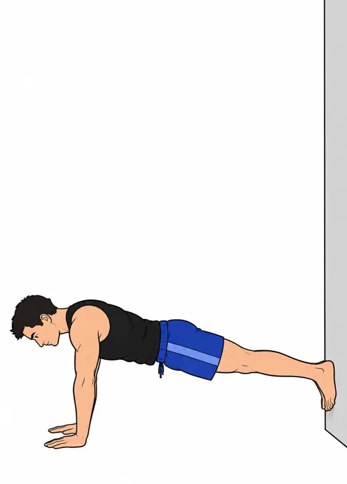 En planche, les mains au sol, les pieds posés contre le bas du mur.